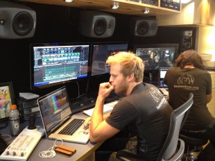 Inside the John Lennon Educational Tour Bus, engineers are working on the production of Sequoia High School's music video for their original song, "We are the Future (Now is the Time)." [Photo by Addie McNamara]