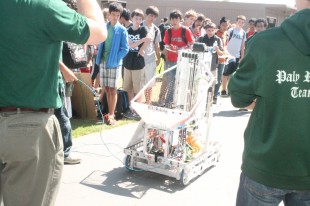 The Paly Robotics Club demonstrates one of their robots for students during Club Day.  The robot, moving independently, tossed a ball up and down, impressing the crowd of students that surrounded the demonstration.
