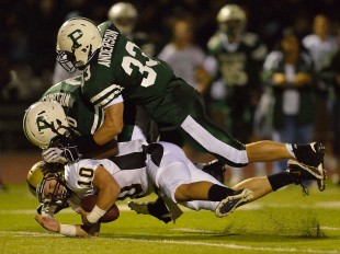 Erik Anderson (33) and Deante Williams (80) bring down Mitty's quarterback for a sack in Paly's home opener loss against the Monarchs Friday night.  Photo by Matt Ersted.