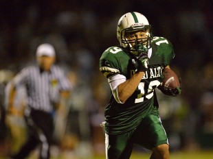 Running back Matt Tolbert runs to the corner of the end zone for a seven yard touchdown in Paly's home opener loss against Archbishop Mitty High School Friday night.  Photo by Matt Ersted