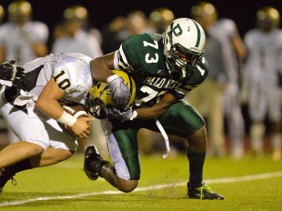 Defensive end Larry Allen sacks the quarterback in Paly's home opener loss against Archbishop Mitty Friday night.  Photo by Matt Ersted.