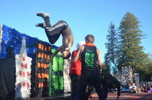Noam Hurwitz manages a flip during the seniors' spirit dance, theme Matrix. [Photo: Cathy Rong]