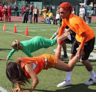 The freshmen compete against the seniors during the wheel barrel portion of the relay race. The seniors won the race, moving onto the final round. Photo by Phoebe So.