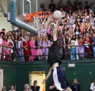 Junior Nick Sullivan tries for the slam dunk during the after-school rally. [Photo: Cathy Rong]