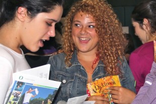 Juniors Julia Rubinov and Lisie Sabbag meet up after visiting multiple college stands at the 2011 Palo Alto College Fair at Paly. Students should attend this year's fair at Henry M. Gunn High School, if they want to get a more open feel of colleges because this fair is open to private colleges and out-of-state public and private colleges and does not include UCs or USCs colleges, according to Gunn College and Career Information Specialist Leighton Lang. "Sometimes high school seniors and juniors are so narrow with [their] college choices that this college fair is a time for students to open up and see some of those schools that they probably haven't thought about," Lang said.
