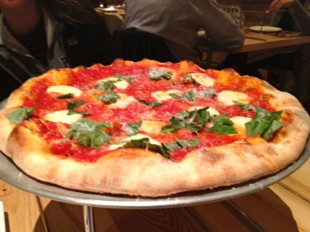 The margherita pizza, $13, was dotted awkwardly with cheese and basil, but was flavorful and cooked just right. Photo by Addie McNamara.