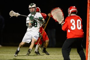 Senior Jonny Glazier attempts to deke the opposing goalie in Paly's close loss to Burlingame High School Monday.  Photo by Matt Ersted