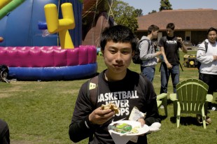 Junior William Yang enjoys one of the burgers paid for by the Associated Student Body and served by the Parent Student Teacher Association.