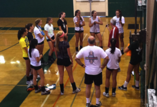 The Palo Alto High School girls Volleyball team huddles up in the Big Gym before practice. The Vikings are preparing for their first home game versus the Castilleja Alligators. They hope to have a strong season.