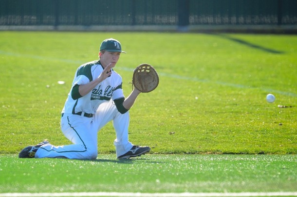 Senior first baseman Rowan Thompson fields a sharp grounder from his knees in the first inning of Paly's first home game against St. Ignacius High School.  Photo by Matt Ersted.
