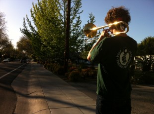 Junior Freddy Kellison-Linn practices marching with his trombone. Kellison-Linn, along with the rest of the Paly band, will be marching in the May Fete Parade Saturday, May 4. Photo by Paige Esterly 