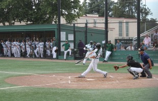 Senior first baseman Rowan Thompson grounds a ball up the middle as the rest of the team looks on from the dugout in Paly's 12-4 win over Watsonville Wednesday.