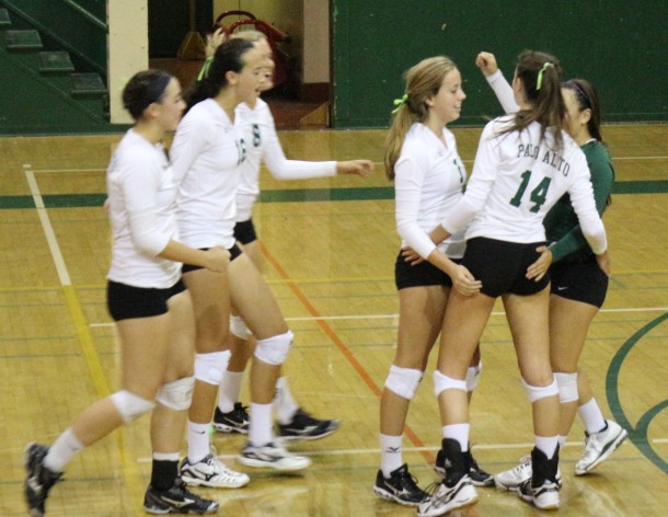 Becca Raffel (14) celebrates with her teammates after winning a hard-fought rally against Castilleja. The Vikings swept the Gators in three sets. Photo by Liana Pickrell.