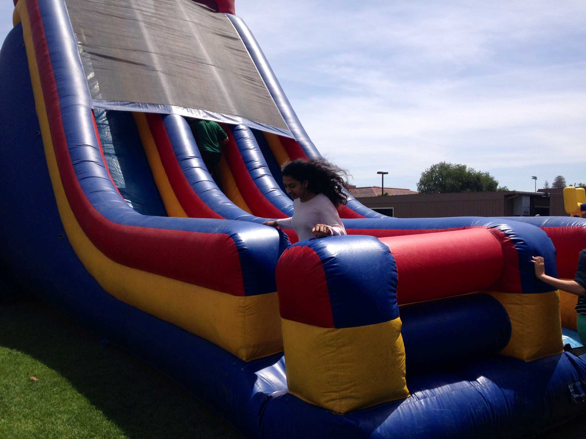 Junior Meera Bhide exits a large, blow-up slide that is included at every field day. Photo by Amanda Carlsson.