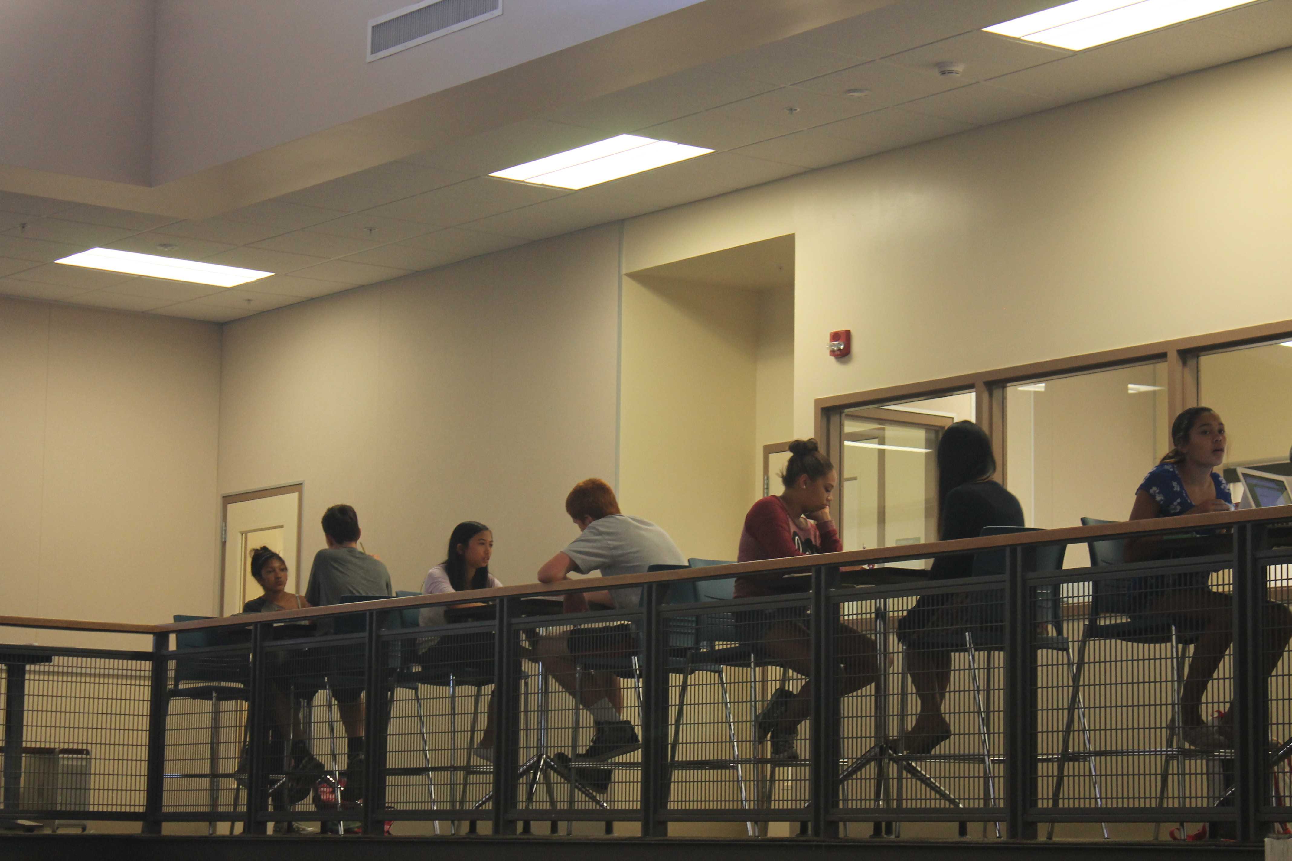 Students study at high-rise tables on the second floor of the Media Arts Center. Photo by Adele Bloch.