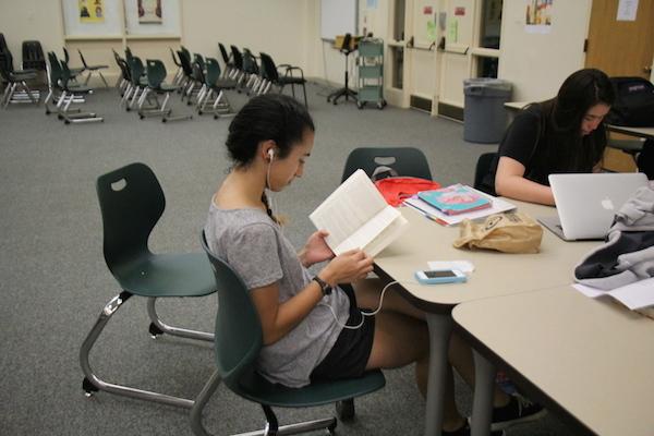 Sophomore Ciara Bleahen and sophomore Alicia Mies use their iPhones to listen to music and study in the library. Photo by Ana Caklovic.