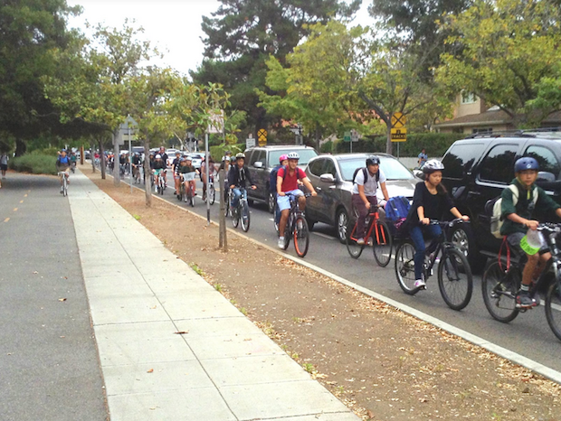 Due to the Caltrain crossing and traffic light, a large group of students will often aggregate in front of the Churchill and Castilleja intersection.“The second that a train passes by, all of the bikers rush towards the school entrance and block off a good portion of the road,” according to Palo Alto High School junior Spencer Yu. Photo by William Zhou.  