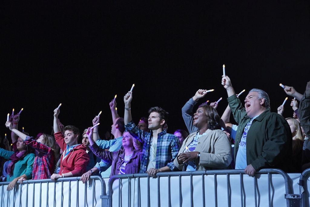 Cast of Parks and Recreation wave glowsticks at the during the season 6 finale. Photo from NBC Universal