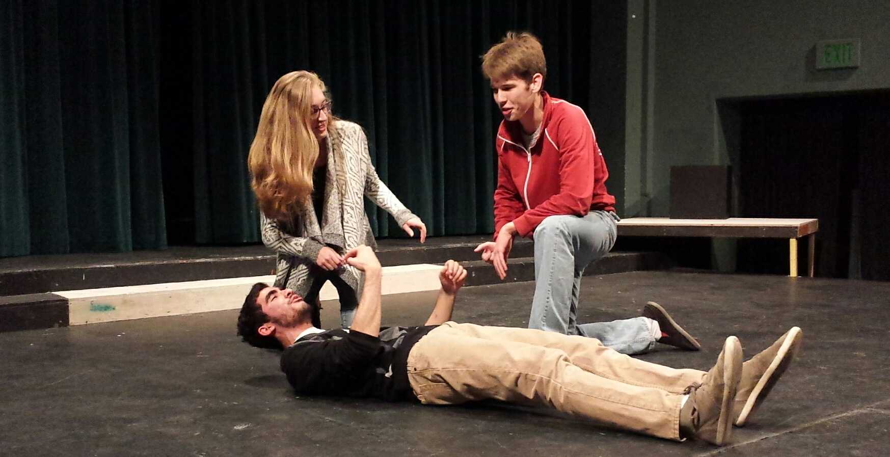 Sophomores Andrea O'Riordan and Joey Kellison-Linn attempt to revive junior Paul Bleich in an improv game called "Countdown," as practice for the upcoming competition on Friday. O'Riordan and Kellison-Linn will be among the six troupe members competing. Photo by Hannah Nguyen. 