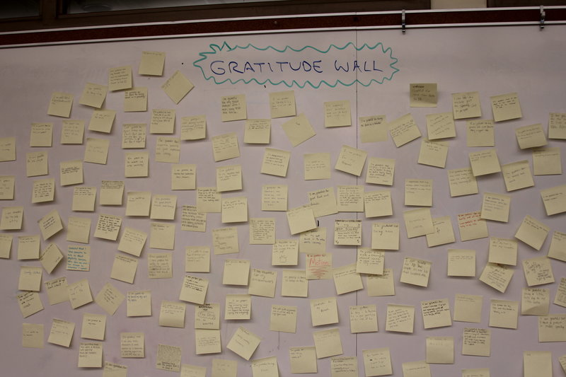 The "Gratitude Wall" in the classroom of AP Economics teacher Eric Bloom features sticky notes of things that Paly students are grateful for. Several Paly teachers invited students to participate in this activity on Monday after the school was informed of the death of a Gunn senior this past weekend. Photo by George Lu. 