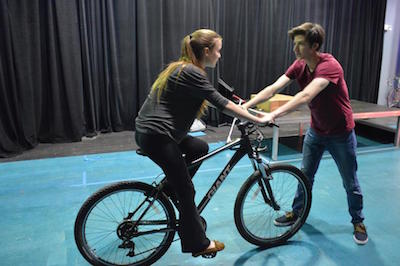 Sophomore Zoe Sego plays the lead character Ora. Junior Ophir Sneh holds onto the "ghost bike." Photo by Ido Gal.