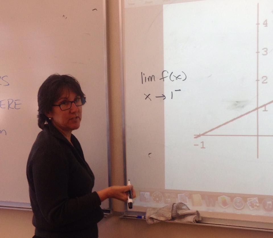 Bowers teaching an Introduction to Analysis and Calculus Class about limits. Bowers will replace Fung as Athletic Director next year, though she will still teach one math class.