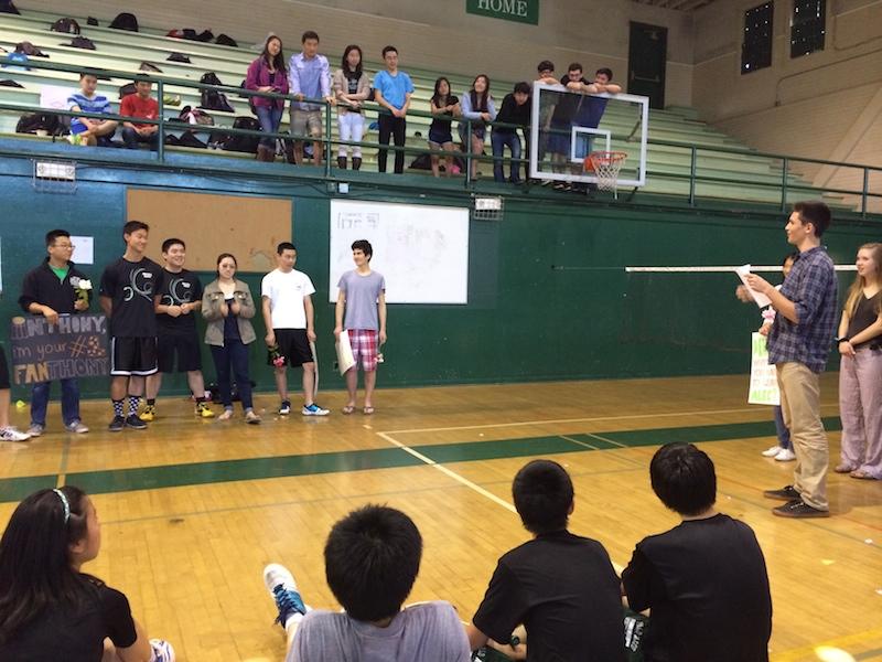 Sophomore Josh Code speaks about Senior Alec Deng on Palo Alto High School's senior badminton night. Before an eventual 18-12 victory versus Lynbrook, the team gathers around to hear the speech. Photo by Jeanette Wong.