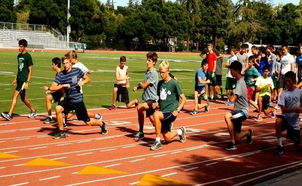 The Palo Alto High School boys’ cross country team warms up during practice at the Paly track. After finishing third 