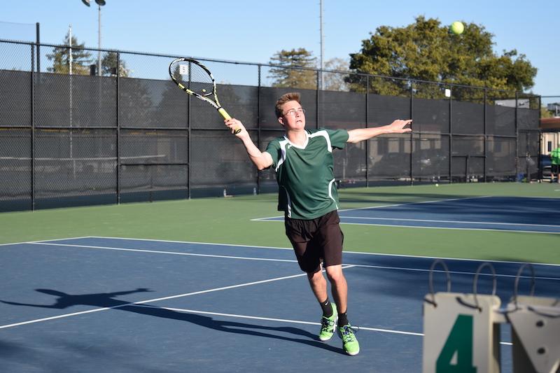 Junior Adrian Smith swings back his racket to return the ball in a doubles match against Cupertino on Thursday at Paly. Photo by Sam Lee.