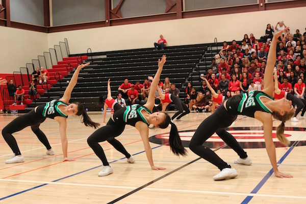 Paly dance team members (left to right) junior Nathalia Castillo, senior Melanie Guan and senior Emma Sternfield perform in a collaboration between the Paly and Gunn dance teams at the first ever Paly vs. Gunn night rally on Thursday at Gunn. Photo by Emma van der Veen.