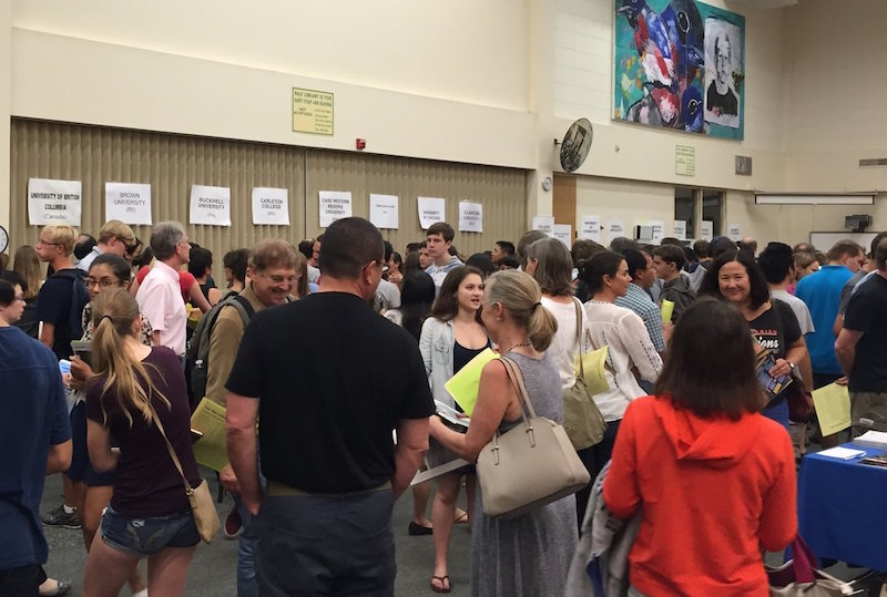 Parents and students visit the Palo Alto Unified School District annual College Fair at Palo Alto High School to receive information on various schools. Photo by Ethan Kao.
