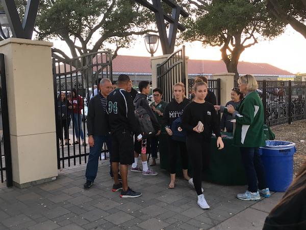 Palo Alto High School students wait in line to enter tonight's home football game against Archbishop Mitty High School. Assistant principal Jerry Bergson says that the procedure was implemented to help keep football games safe.