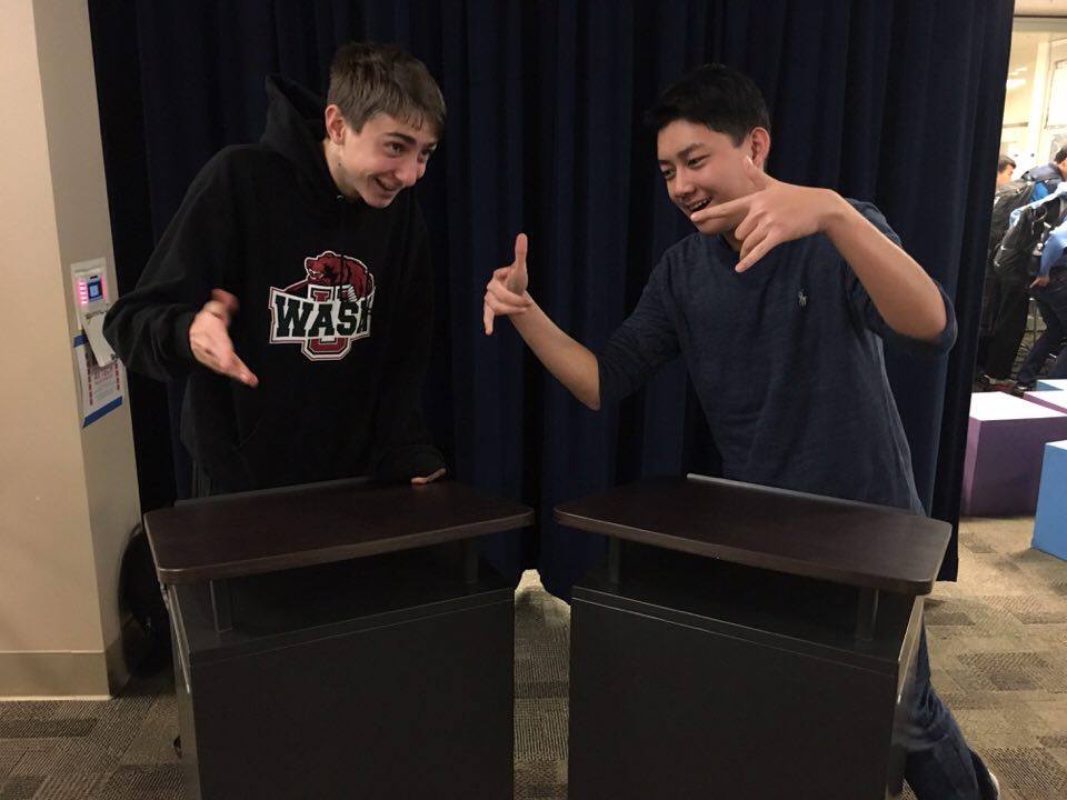 Senior debater Colin Fee (left) and junior debater Barry He (right) passionately discuss their debate successes and excitement for their bright futures. 