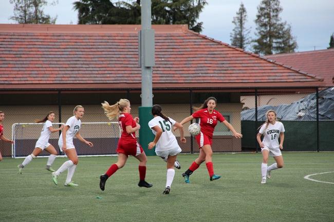 Senior captain Natalie Maloney attempts to make a pass to freshman Sophie Vogol. Maloney would go on to score four goals for Paly in their 11-0 rout of El Camino High School. Photo: Sam Lee
