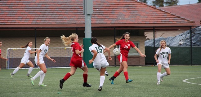 Senior midfielder and captain Natalie Maloney attempts to make a pass to freshman forward Sophie Vogel, who makes a cut towards the goal. Maloney would go on to score four goals for Palo Alto High School, in its 11-0 rout of El Camino High School on Thursday at home. Photo: Sam Lee.