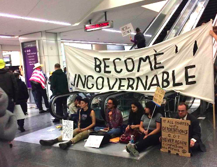 Locals gather at SFO in an effort to pressure officials to release five detainees as a result of Trump’s recent travel restrictions. Photo by Harrison Frahn.