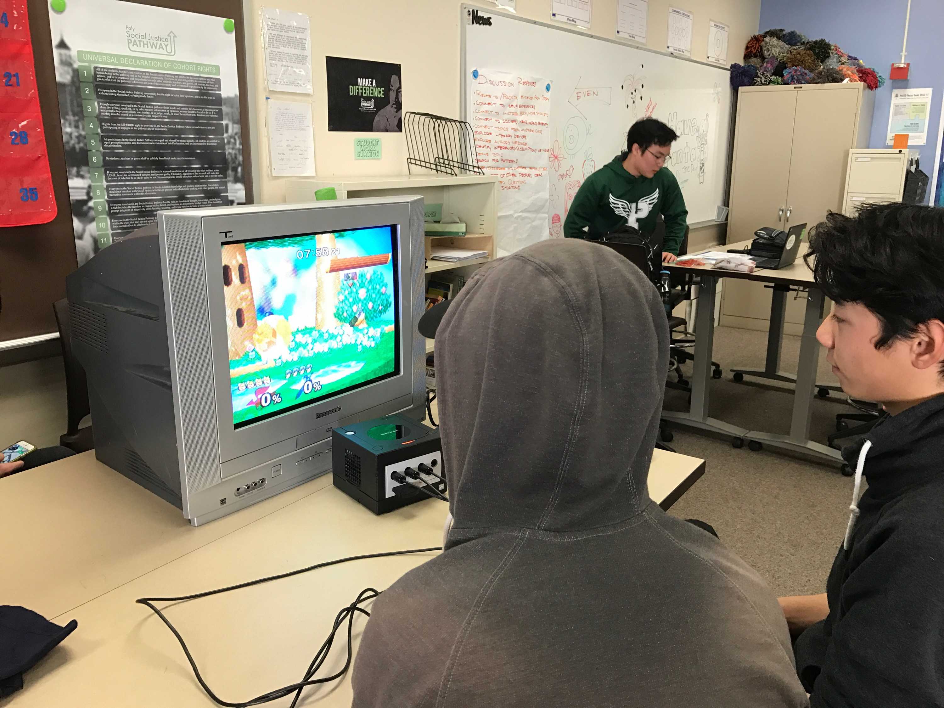 Sophomore Vice President Anthony Xie, right, and senior Tai Nguyen, middle, battle on Smash melee during a club meeting on Jan. 30. Although Xie won this time, Nguyen is almost always the victor. “He was going easy on me,” Xie says.