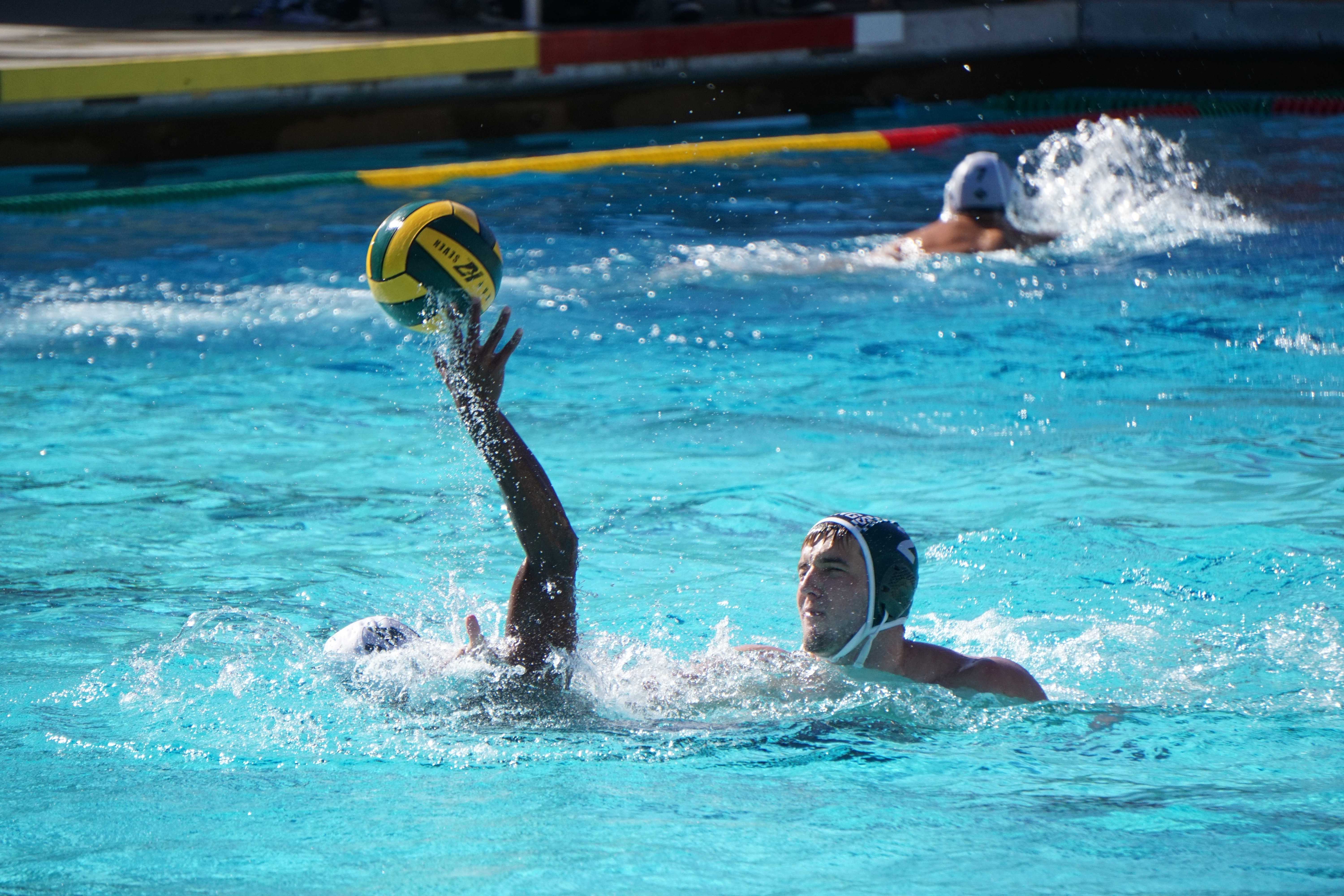 Senior Jack Andersen drowns a Harker player while trying to prevent a shot on goal. [quote from jack]. Paly stepped up their intensity in the second half, outscoring Harker by four goals, and won comfortably, 9-5. Photo by Benner Mullin