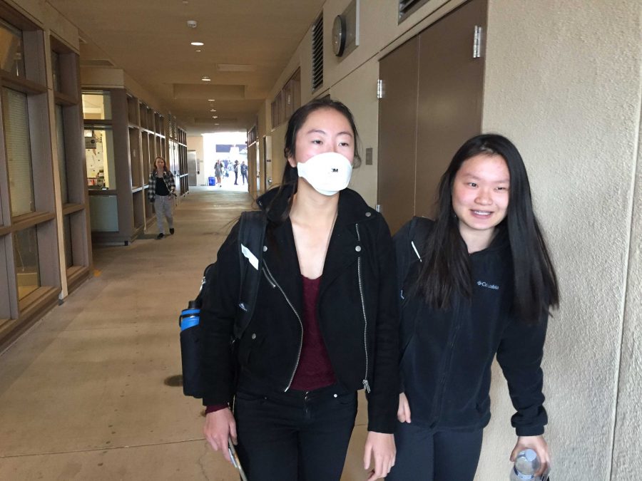 Stephanie Yu wears a mask to prevent breathing in the smoke. Many students wore masks or used their hoodie to cover their mouth and nose. Photo: Samantha McBride 
