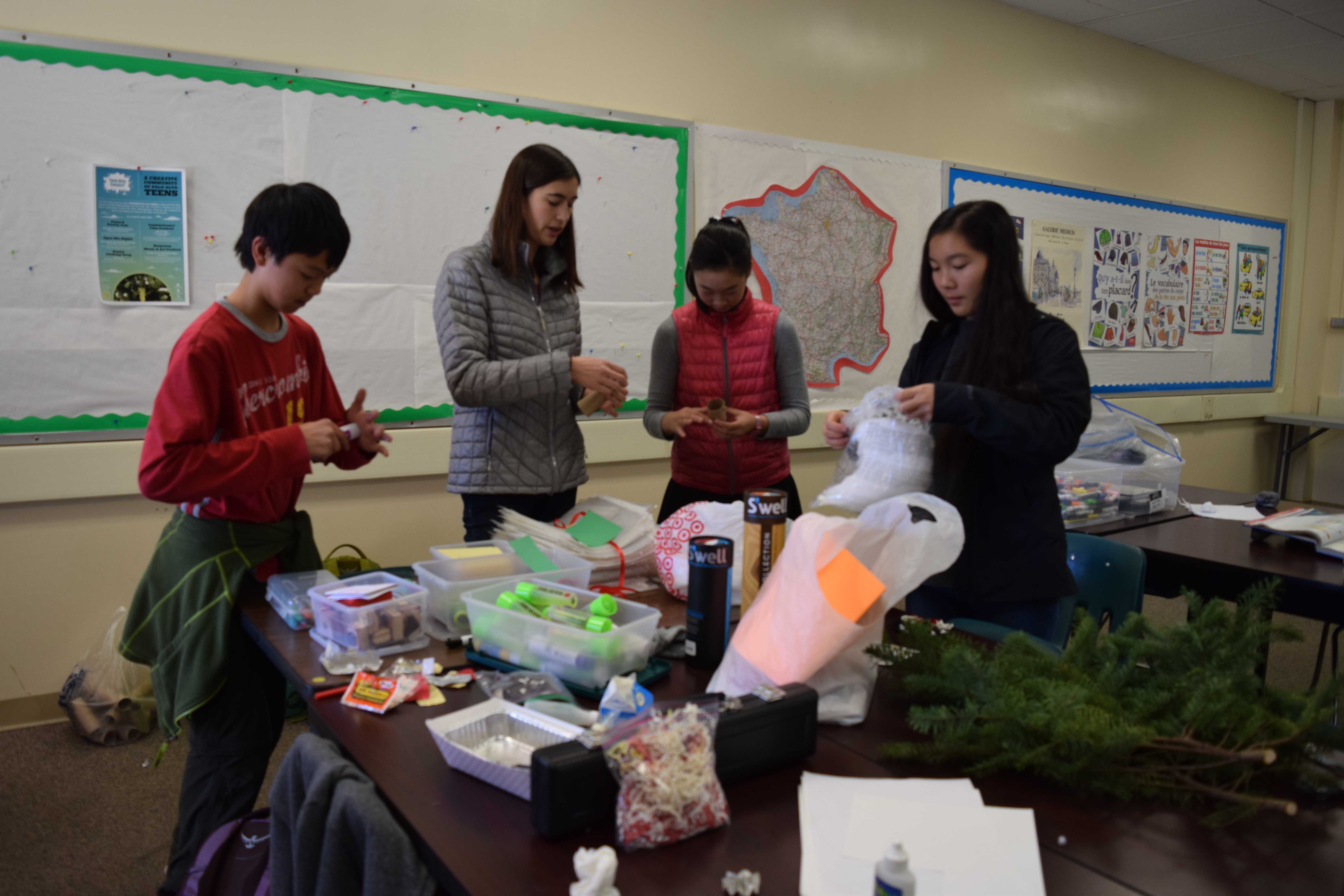  Members of Zero Waste Initiative Club Zander Leong, Olivia d'Arezzo, Aileen Wu and Club President Leila Tjiang (from left to right) prepare for tomorrow's Tap Out Tuesday event. Their booth will allow students to make holiday decorations out of old recyclables which they are welcome to take with them. "You can take it home to enjoy for the holidays, or offer it to a friend as a present," Tjiang said. Photo: Micaela Wong 