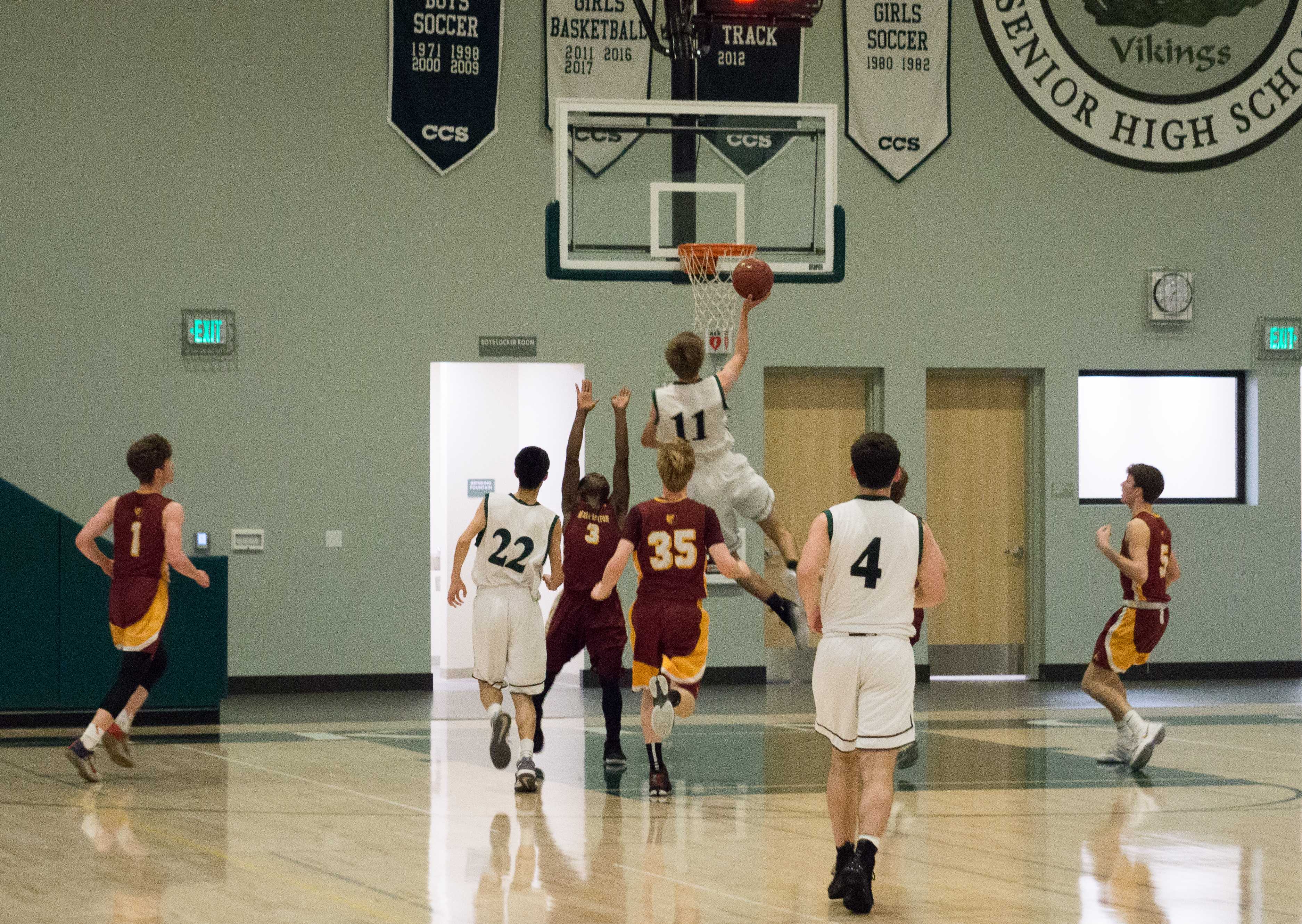 Senior forward Max Dorward, who led Paly with 17 points, shoots a layup over a defending Menlo-Atherton player. The Vikings played stout defense all night and attacked the paint on offense, resulting in a 57-41 win at the Peery Family Center. "We played our usual man defense and we bothered M-A’s rhythm on offense," head coach Peter Diepenbrock said. Photo: Finn Mennuti