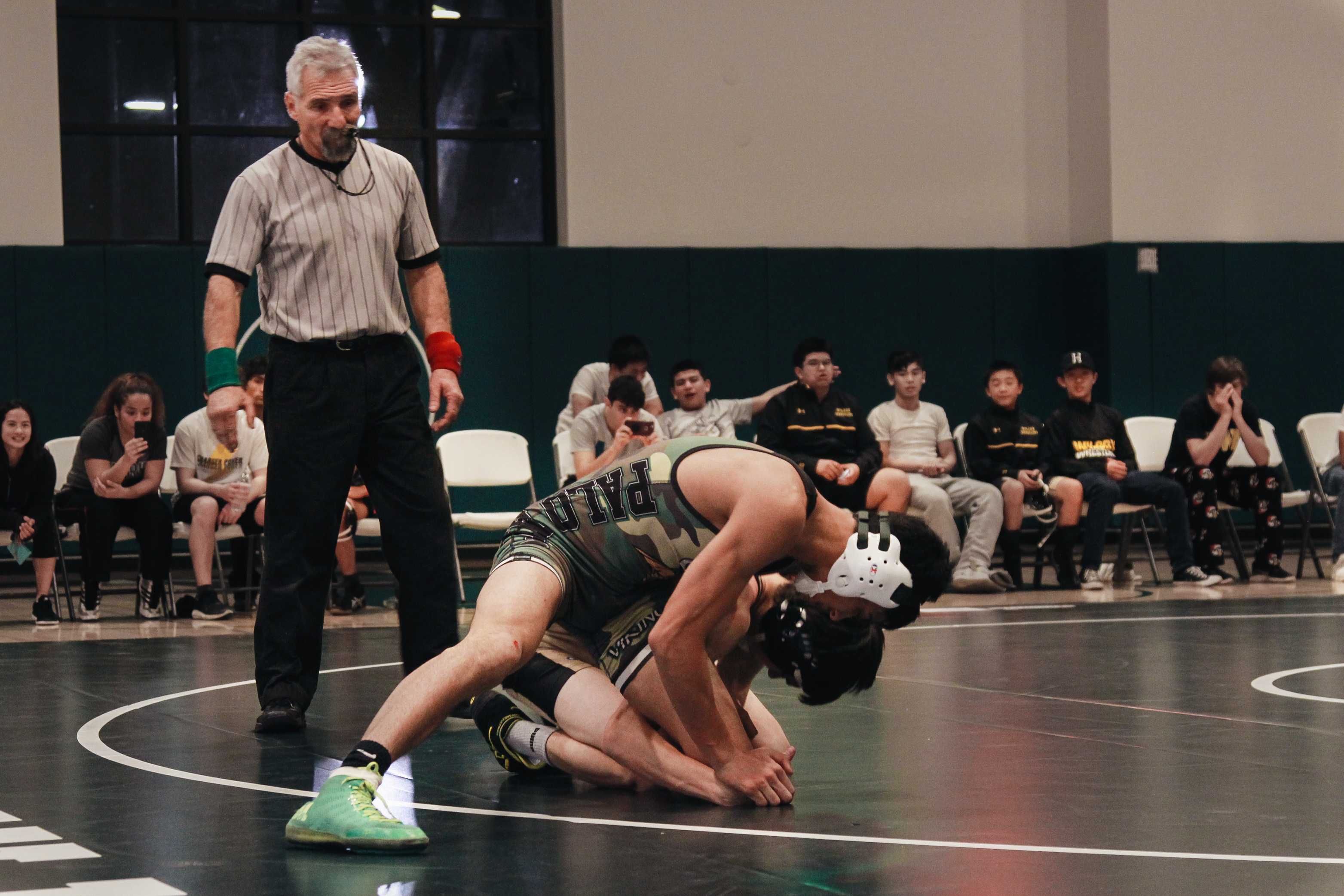 Palo Alto High School senior and co-captain Calvin Grewal pins down his opponent at a dual meet against Fremont High School. Though Grewal won his match, the team did not do as well, finishing 43-31. "We just have to keep going, keep our heads up, and keep fighting," coach Jonathan Kessler said. Photo: Angelina Wang.