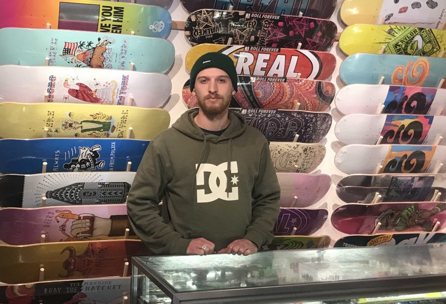 Manager Jake London stands at his counter top in Society Skate Shop ready to greet customers. The owners are passionate about motivating more people to skateboard. We try to be very welcoming to anyone who has an interest in skateboarding if they are curious about it. Photo: Eddie Wang.