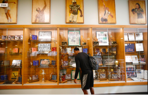 Paly alumnus KeeSean Johnson (14) visits the Peery Family Center at Palo Alto High School where a portrait of Davante Adams, a mentor of Johnsons, as well as a Paly alumnus who now plays for the Green Bay Packers, is displayed. Johnson was picked by the  Arizona Cardinals in the sixth round of the 2019 NFL draft. Former coach Jason Fung described Johnson as a “hard-working kid, always had dreams and aspirations to play football.” Photo provided by: Fresno State fundraising department