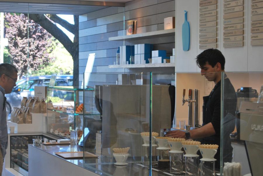 A customer waits to order at the recently opened Blue Bottle Coffee shop at Stanford Shopping Center. Customer Gabbi Irwin says she thinks the location is convenient and plans to come frequently. “I really like the atmosphere of the place,” Irwin said. “It’s really nice.” Photo: Hallie Faust