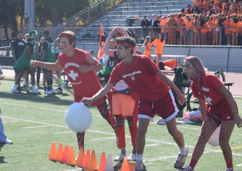 Four students from the class of 2022 participated in a super-sized game of cornhole at the lunchtime rally Wednesday at the Palo Alto High School Viking Stadium. “We were louder than we were last year, which is awesome,” sophomore Owen Rice said. “[Our] cheers are better.”