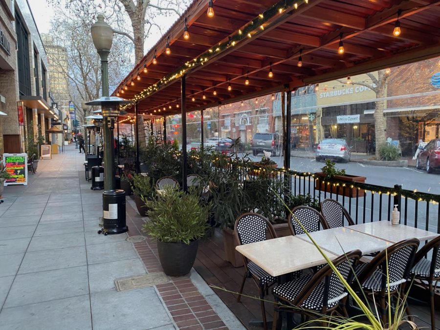 Outdoor dining outside of a restaurant on University Avenue in Palo Alto. Indoor dining is now allowed as a result of the county's move into the state's less restrictive Red tier.