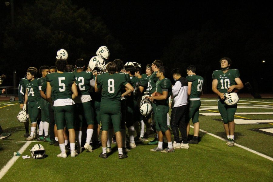 Palo Alto High School student-athletes huddle after a game with no masks or social distancing. With the end of the pandemic in sight, Palo Alto Unified School District has done little to spread awareness or enforce social distancing guidelines. I think its a good idea [to socially distance], but I also think that its a really hard thing to implement, sophomore Jonas Pao, who is a member of the boys varsity soccer team, said. The players, the coaches, and even some of the fans might be resistant to it.