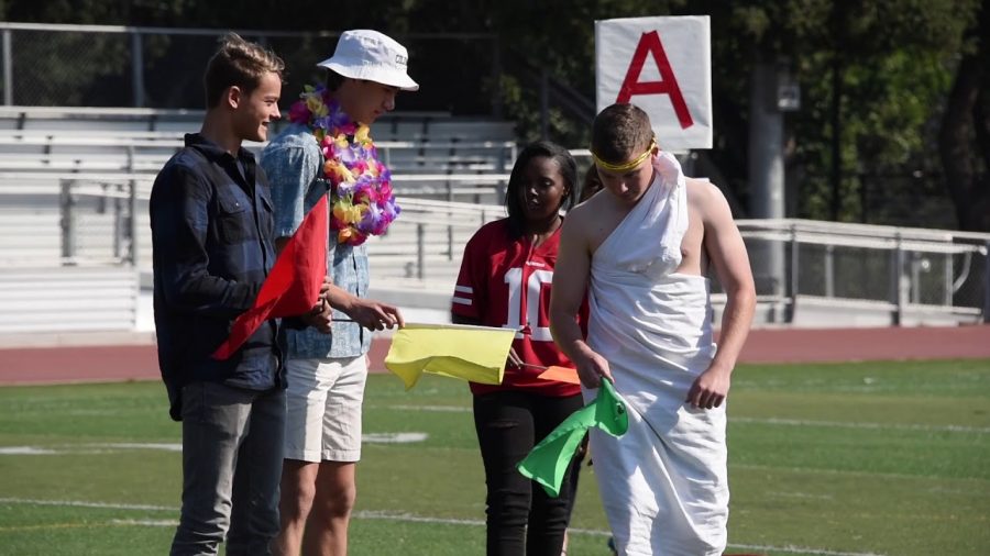 Four Paly students are dressed up for Salad Dressing Day. From left to right: Cowboys, Thousand Island, Sports Wear, and Togas. This photo was taken in 2019, when the Thousand Island theme was still “Beach Day.” “It was originally just a beachwear but people morphed it into a Hawaiian Day,” said Junior Class President Ashley Hung. Photo by Ethan Chen.