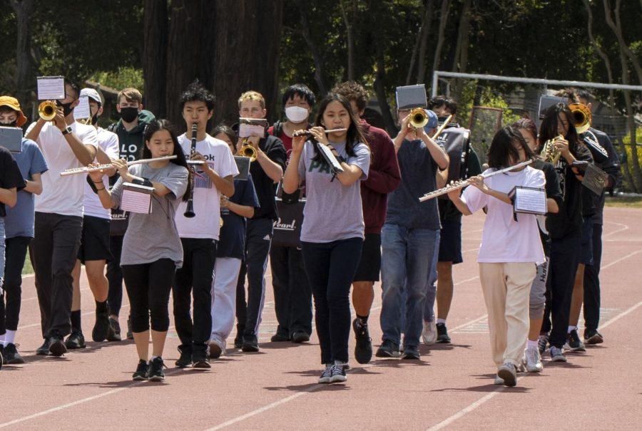 The Palo Alto High School Concert Band practices on the track to prepare for the May Fete Children’s Parade & Fair. The parade will be held for the first time in three years after a hiatus due to the the COVID-19 pandemic. According to Recreation Supervisor Adam Howard, the parade taking place this year is an indication that the pandemic has started to recede and the city can return to planning larger events again. “It feels really good to get back to hosting the parade and other community events,” Howard stated in an email. “There is a lot of excitement and enthusiasm around this event and I’m really happy the community can come together again to celebrate.” (Photo: Arthur Wu)